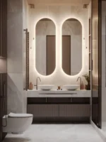 Deux miroirs Evola rétroéclairés posés côte à côte sur un mur, sur-mesure