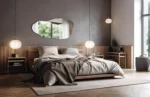 Miroir LED IRIS forme irrégulière installé au-dessus d’un lit dans une chambre moderne et élégante