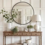 miroir rond avec cadre en métal antirouille posé sur une table console, vue en face, design moderne et élégant