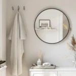 miroir rond avec cadre en métal antirouille vu en face, installé dans une salle de bain moderne